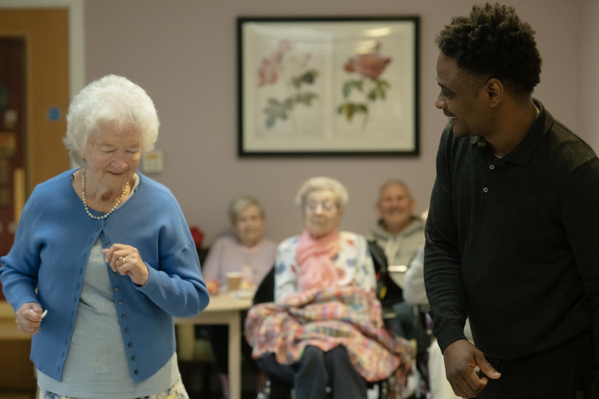 Residents and a staff member enjoying an activity in a community room
